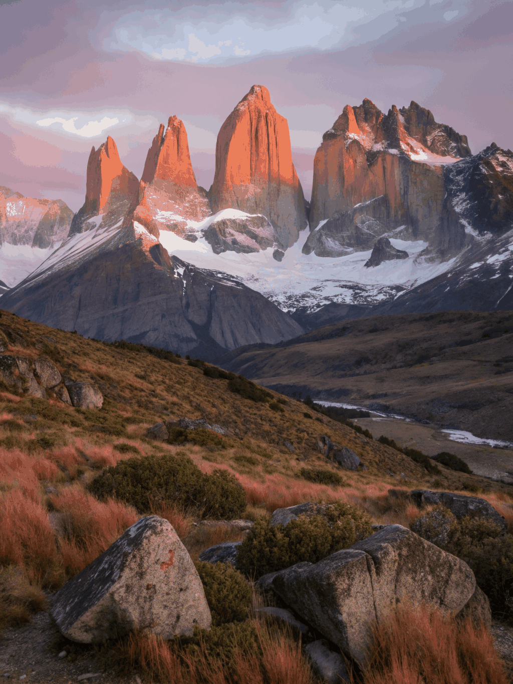 Dawn light hitting granite spires in Patagonia mountains